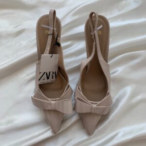 Cream bow patent heel